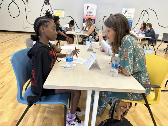 YMCA of Middle TN Chaplain, Dori Gorman, has a conversation with a child in Middle TN.
